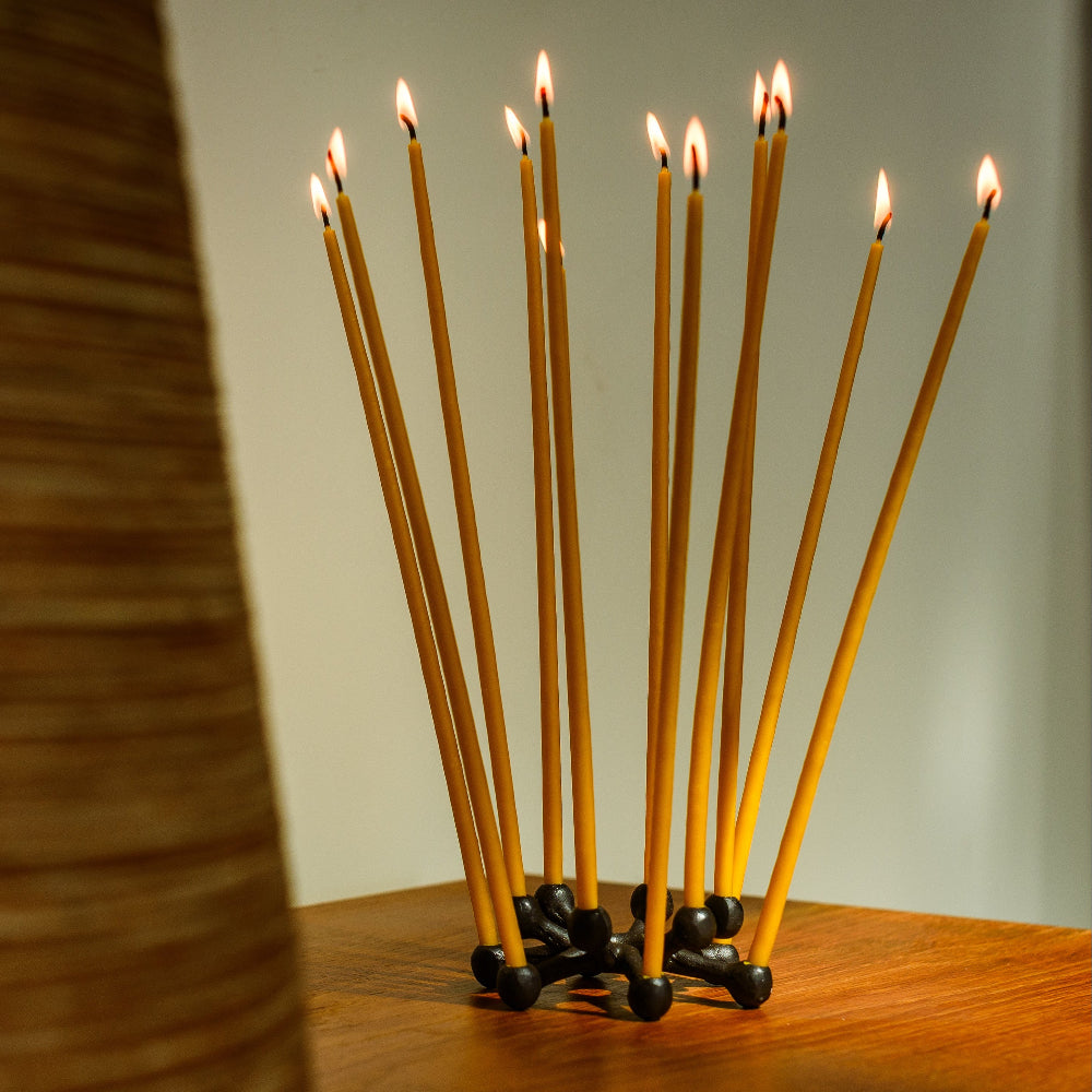 Set of 12 beeswax candles in Dansk Design tiny taper holder.